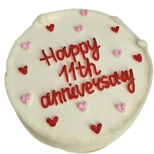 11th anniversary cake with white icing, red hearts, pink hearts, and Happy Anniversary message.