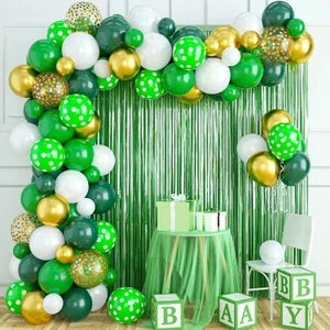14 August balloon garland setup with green, white, and gold balloons, metallic fringe backdrop, and gift table for Independence Day events in Pakistan.