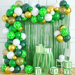14 August balloon garland setup with green, white, and gold balloons, metallic fringe backdrop, and gift table for Independence Day events in Pakistan.