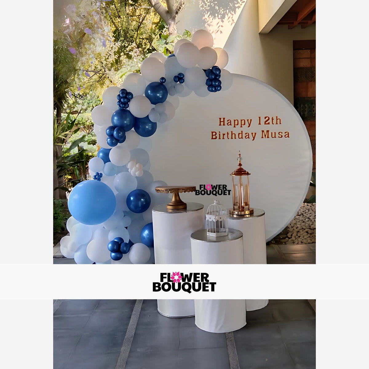 This image showcases a beautifully arranged birthday party decoration, perfect for celebrating a 12th birthday. The centerpiece is a large white circular backdrop with the text "Happy 12th Birthday Musa" written in elegant gold letters. Surrounding the backdrop is an arch of balloons in shades of blue and white, creating a festive and vibrant atmosphere. In front of the backdrop, there are three cylindrical white stands of varying heights, each adorned with decorative items including a golden cake stand and