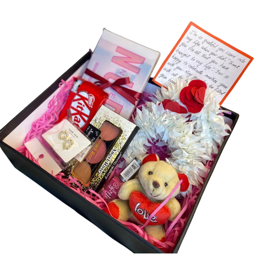 Charming gift box with eyeshadow palette, blush kit, jhumkay earrings, nail paint, teddy bear, artificial gajray, and chocolate.