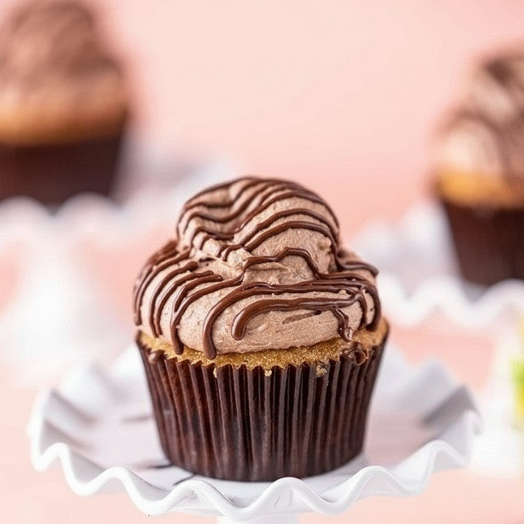 A rich chocolate cupcake topped with creamy chocolate frosting and a drizzle of decadent chocolate glaze, perfect for dessert lovers.