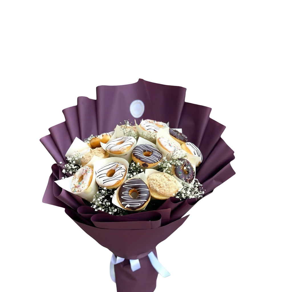 A bouquet of gourmet donuts in various flavors and toppings, including chocolate drizzle and sprinkles, arranged with delicate baby's breath and wrapped in a luxurious purple paper for a sophisticated and indulgent presentation.