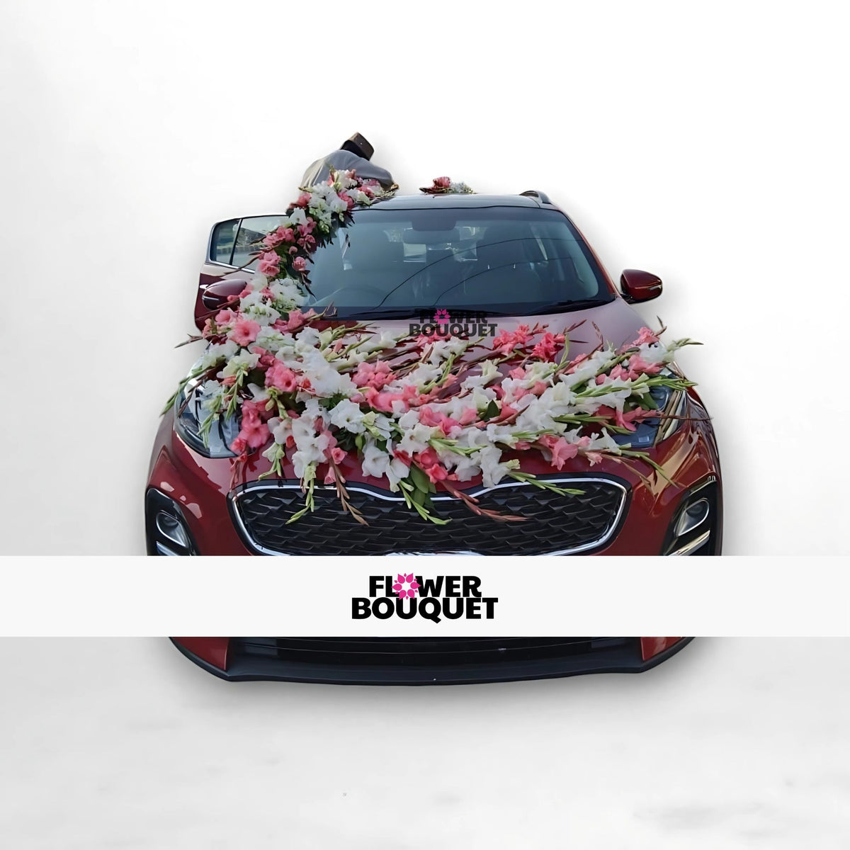 Red car decorated with pink and white flowers on the hood, windshield, and roof.
