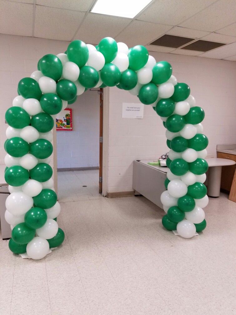 Green and white balloon arch decoration for 14 August office entrance setup in Pakistan for Independence Day.
