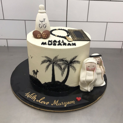 Custom Hajj Mubarak cake with Arabic calligraphy, Kaaba frame, Tasbeeh, and bride & groom toppers