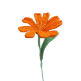 Handmade crochet orange daisy flower with green stem and leaves.