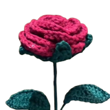 Handmade crochet red rose with green leaves on a long yarn stem.