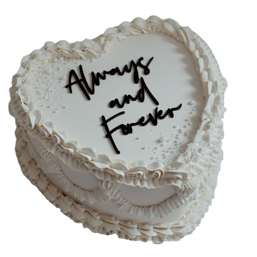 Heart-shaped engagement cake with white cream frosting and Always and Forever message.
