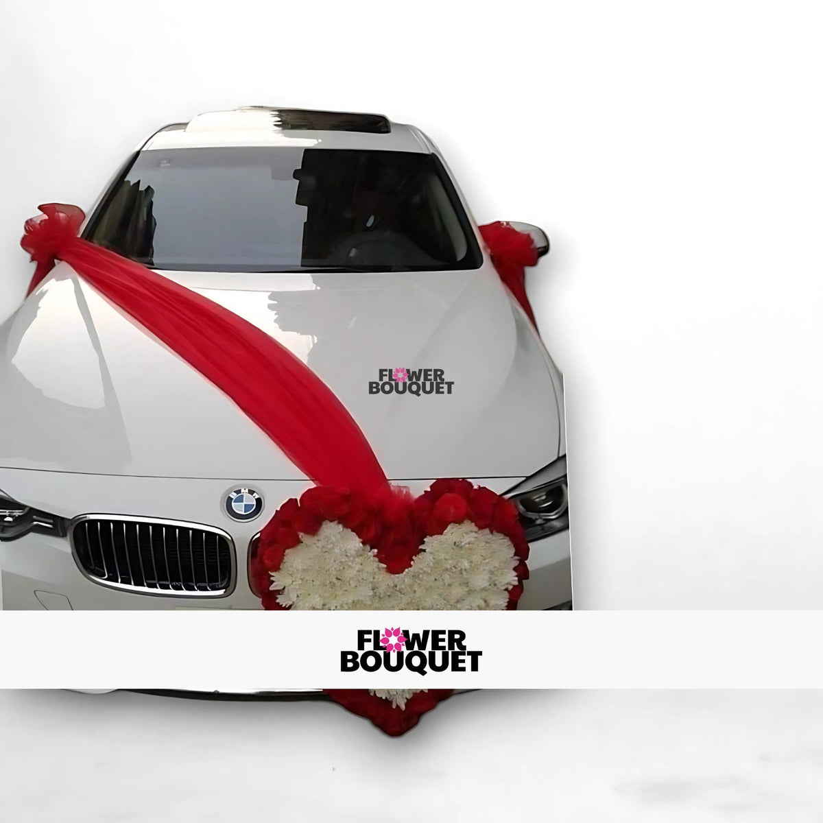 White BMW car decorated with red fabric and a heart-shaped floral arrangement.