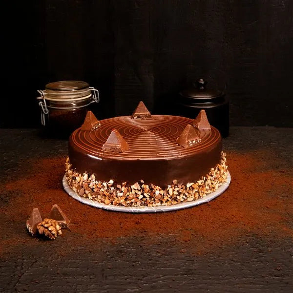 "Jlal Sons Royal Toblerone Chocolate Cake topped with Toblerone pieces and nut coating for delivery in Pakistan"