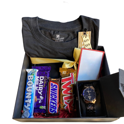 Luxury gift hamper for him with Zellbury black t-shirt, wristwatch, premium perfume, chocolates (Bounty, Dairy Milk, Snickers, Twix, KitKat), and golden ribbon gift box.
