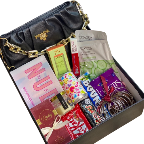 Luxury glam gift box with handbag, Huda Beauty nude palette, Pixi blush, lip gloss, Bioaqua sheet masks, Bonanza perfume, chocolates, bangles, scented candle, and fairy lights.