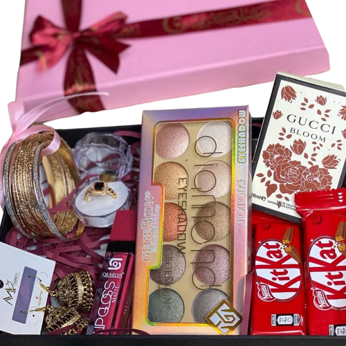Makeup and jewelry gift box with eyeshadow palette, jhumkay earrings, bangles, ring, Gucci Bloom perfume, lip gloss, and KitKat chocolates.