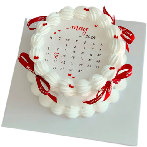 Memorable Date Cake with calendar design, red ribbon bows, and white cream frosting