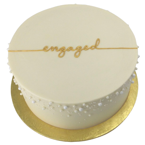 Minimal white engagement cake with golden Engaged topper and pearl decorations.