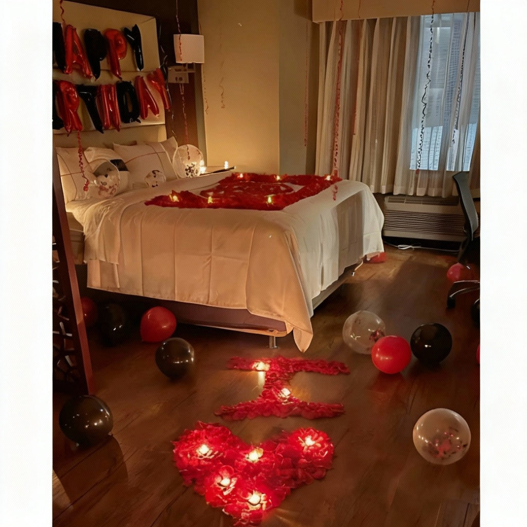 Romantic Birthday Celebration Bed Decor with heart-shaped red rose petals, candles, "HAPPY BIRTHDAY" balloons, and scattered black, red, and confetti balloons.
