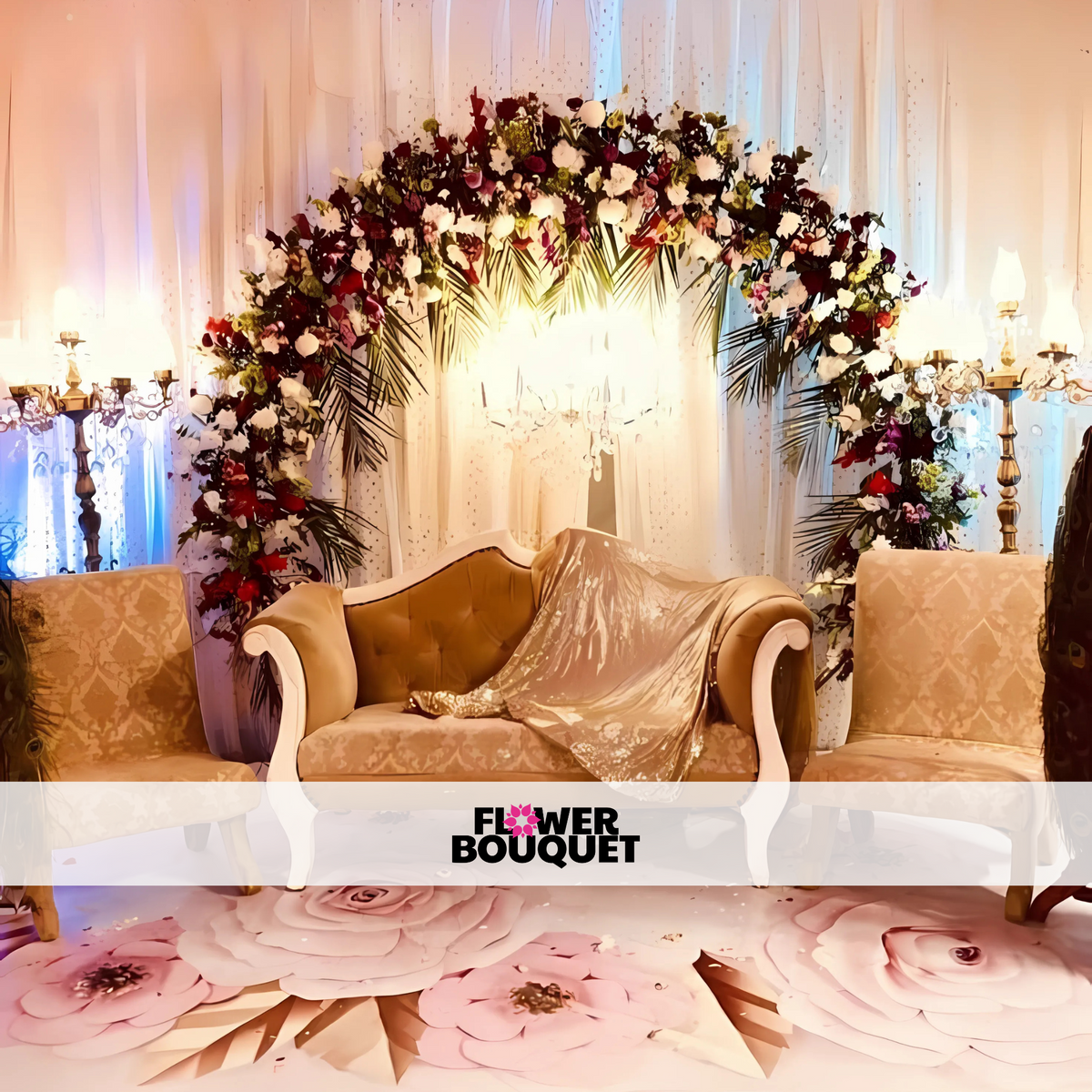 Wedding stage featuring a floral arch with red, white, and purple flowers, gold and cream seating, and a warm white backdrop with candelabra-style lamps.