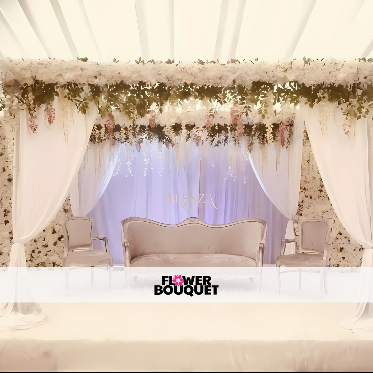 Wedding stage featuring a white floral canopy, flowing drapes, silver tufted sofa, and matching chairs, perfect for luxurious celebrations.