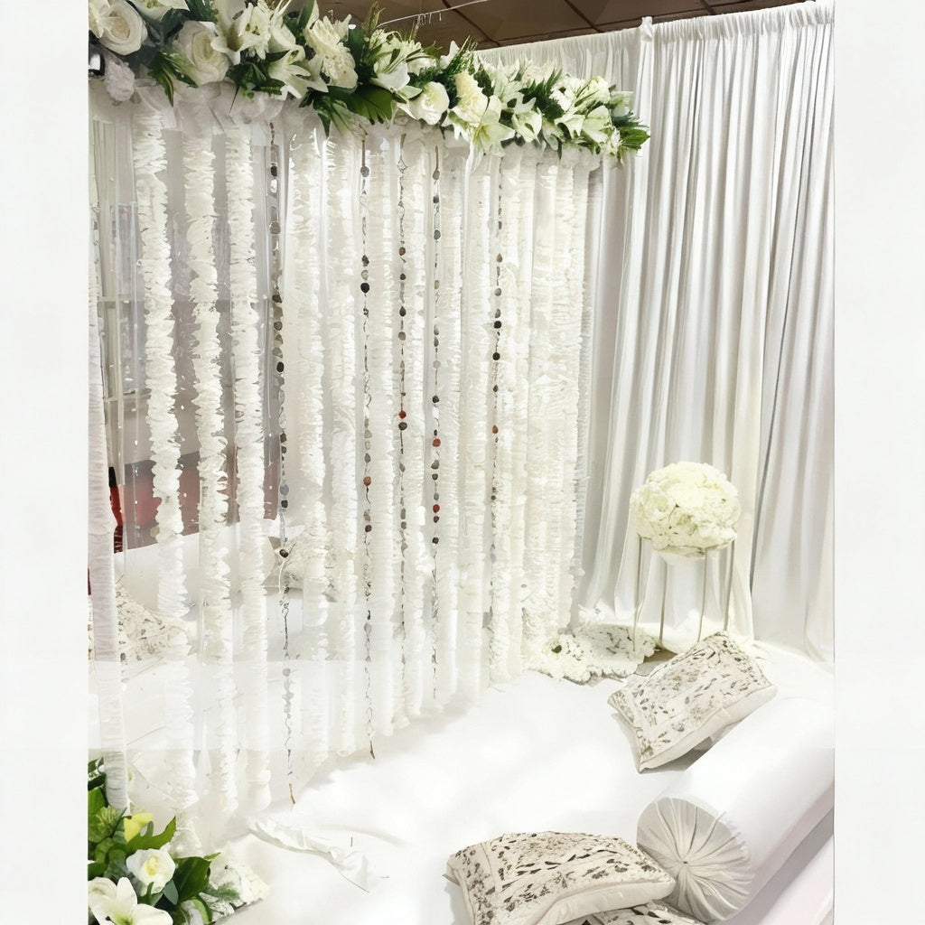 White Nikah canopy with floral garlands and elegant drapes.