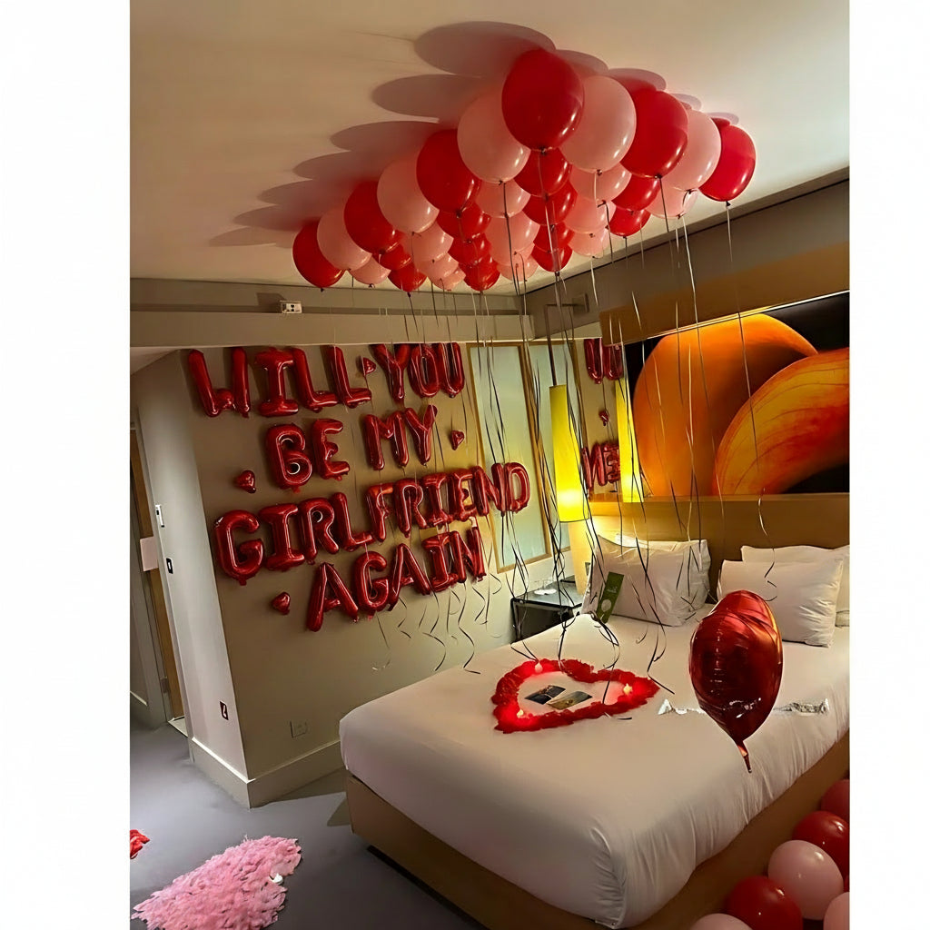 Will You Be My Girlfriend Again Decor with red balloon letters, helium balloons, and heart-shaped bed arrangement.